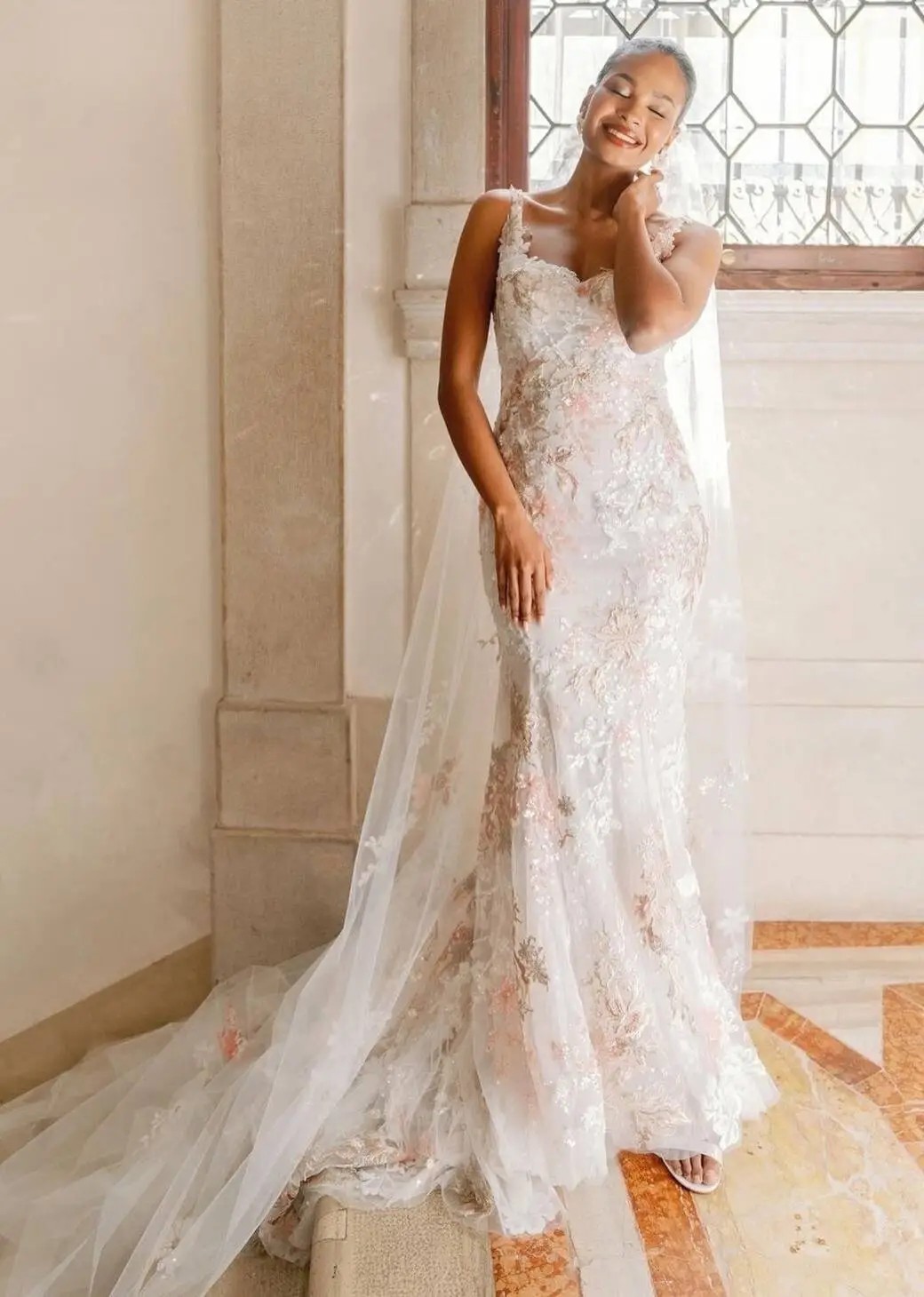 Photo of the smiling model wearing a white gown